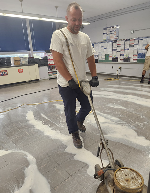 Custodial staff cleaning floors