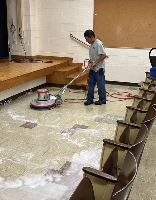 Custodial staff polishing the floor